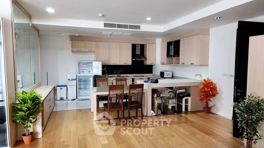 Spacious modern kitchen with wooden flooring and open layout design