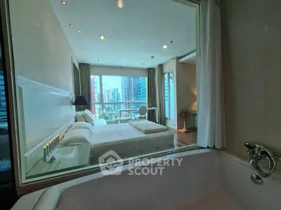 Luxurious bedroom with city view and in-room bathtub, perfect for urban living.