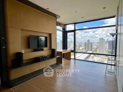 Spacious modern living room with panoramic city view and sleek wooden flooring.