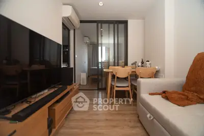 Modern living room with sleek furniture and open layout in cozy apartment.