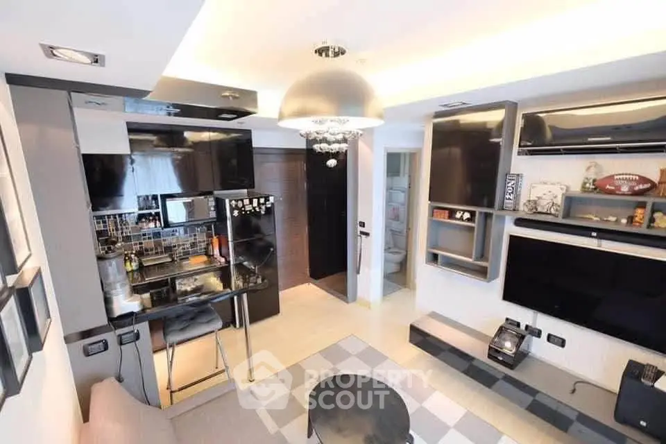 Modern living room with open kitchen, sleek design, and contemporary decor in a stylish apartment.