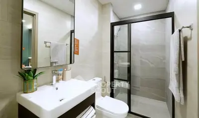 Modern bathroom with sleek shower and stylish vanity in contemporary home.