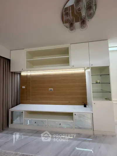 Modern living room with built-in storage and elegant lighting