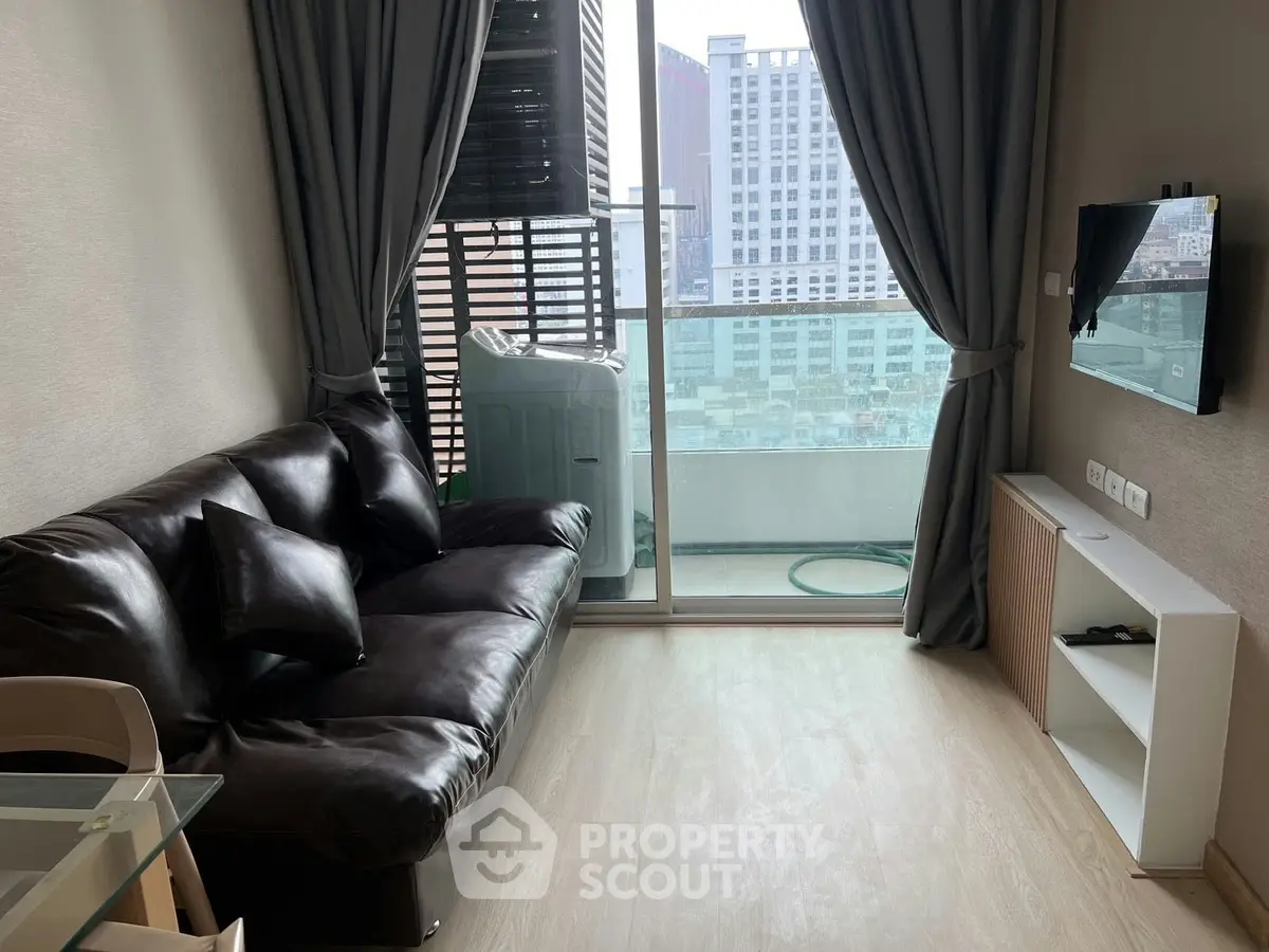 Modern living room with leather sofa and city view balcony in high-rise apartment