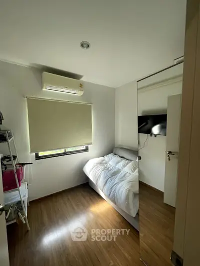 Cozy bedroom with natural light and modern air conditioning unit.