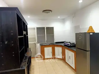 Spacious kitchen with modern appliances and ample storage in a well-lit interior.