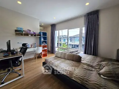 Spacious bedroom with study area and large window view