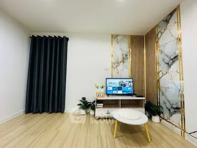 Modern living room with stylish decor, marble accent wall, and sleek TV setup.