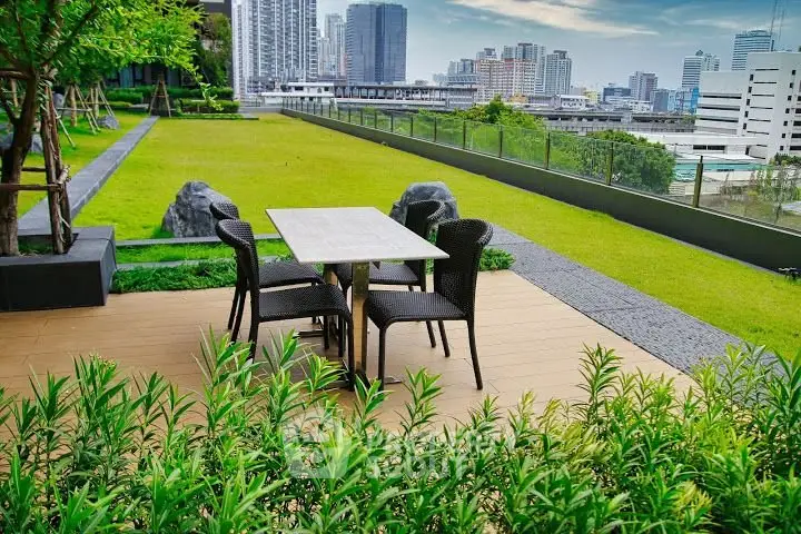 Stunning rooftop garden with city skyline view and outdoor dining area.