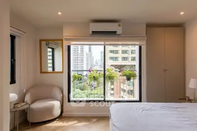 Bright bedroom with city view, air conditioning, and modern decor in urban apartment.