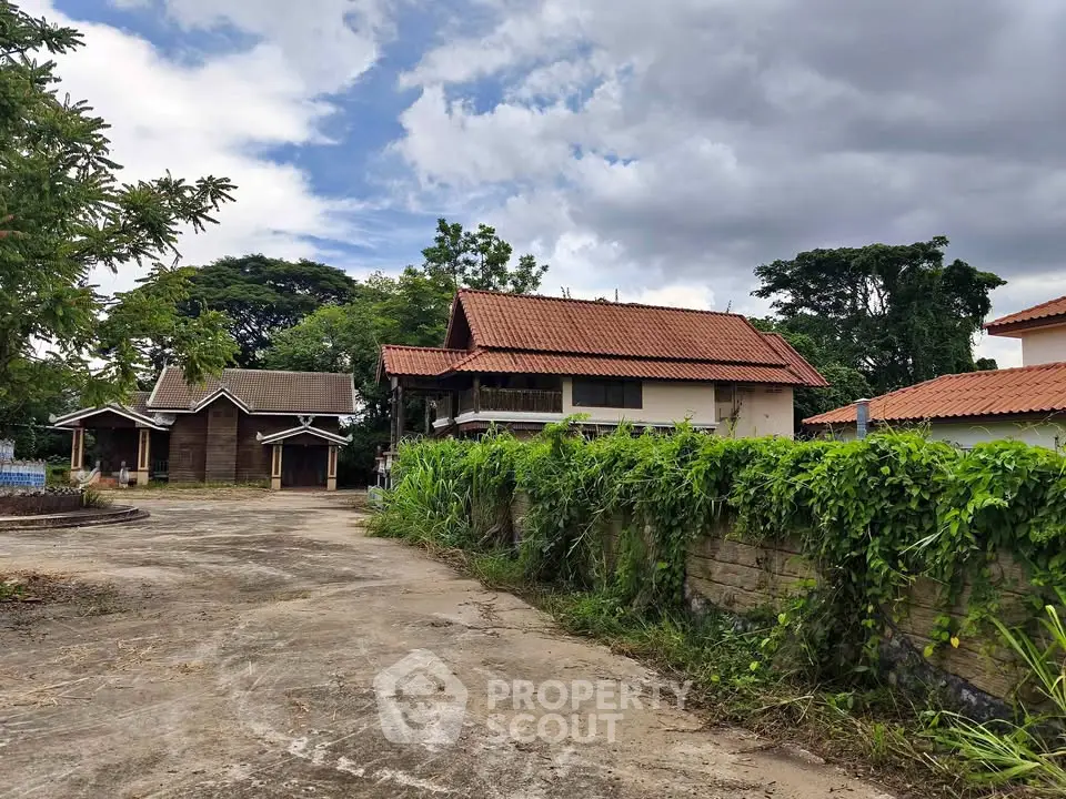 Charming rustic property with lush greenery and traditional architecture, perfect for serene living.