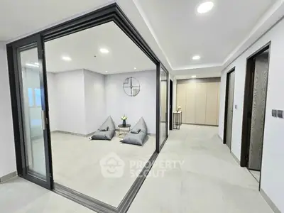 Modern minimalist interior with sliding glass doors and cozy seating area.