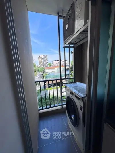 Compact balcony with washing machine and city view