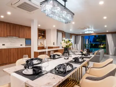 Luxurious open-plan dining and living area with elegant decor and modern lighting