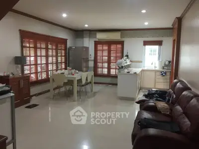 Spacious living room with open kitchen layout and modern furnishings