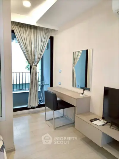 Modern bedroom with balcony access and sleek furniture design