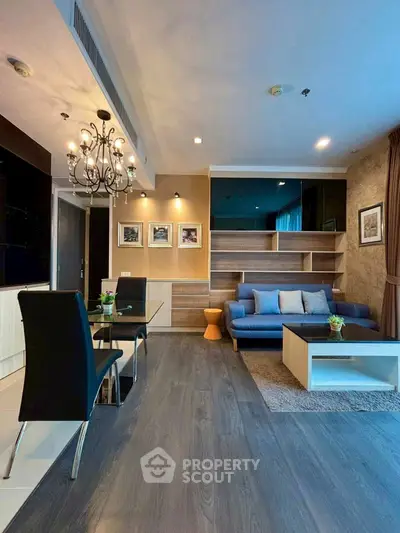 Modern living room with elegant decor and spacious layout, featuring stylish furniture and ambient lighting.