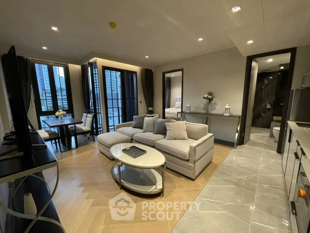 Modern living room with elegant decor and open layout, featuring a cozy seating area and stylish dining space.