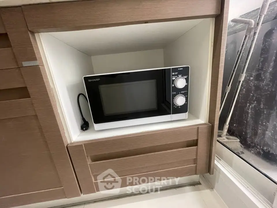 Modern kitchen with built-in microwave in sleek cabinetry