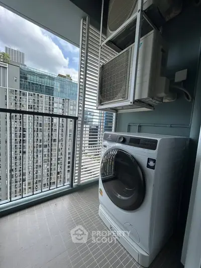 Modern high-rise balcony with washing machine and city view, perfect for urban living.