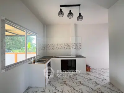 Modern minimalist kitchen with open layout and stylish lighting fixtures