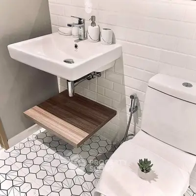 Modern bathroom with stylish sink and geometric tile flooring