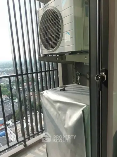 Modern balcony with air conditioning unit and city view, perfect for urban living.