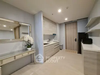 Modern kitchen with sleek cabinetry and elegant decor in a stylish apartment.