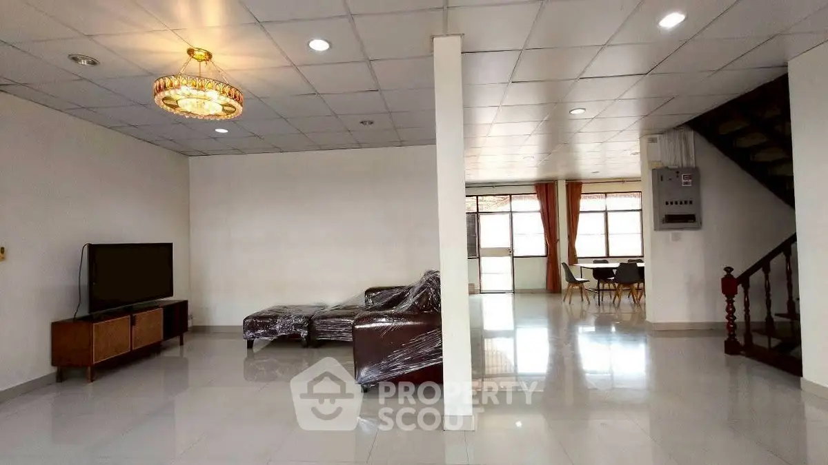 Spacious living room with modern furniture and elegant lighting