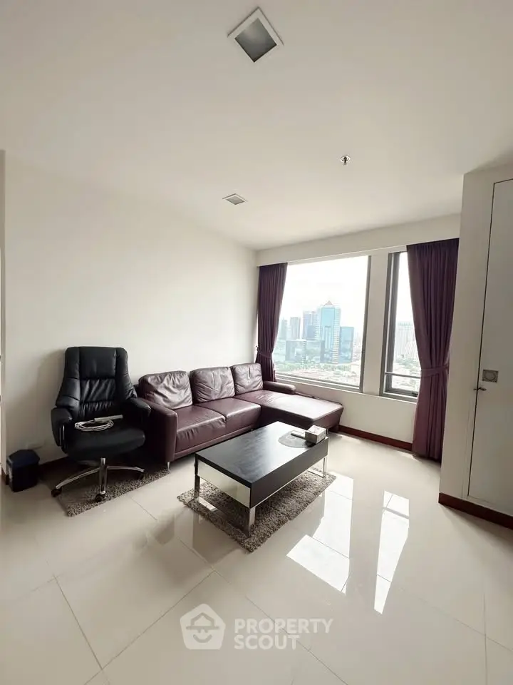 Spacious living room with city view, featuring modern leather sofa and sleek coffee table.