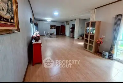 Spacious living room with elegant decor and ample natural light, perfect for family gatherings.