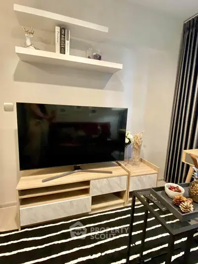 Modern living room with stylish TV stand and decorative shelves, perfect for cozy entertainment evenings.