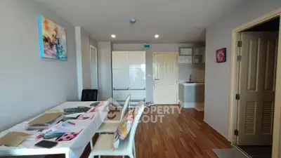 Modern apartment interior with stylish dining area and compact kitchen