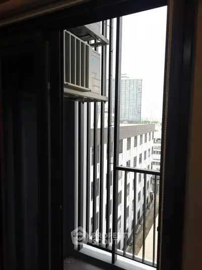 Modern apartment balcony with city view and air conditioning unit, perfect for urban living.