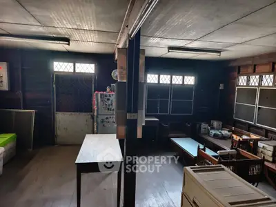 Spacious rustic interior with wooden floors and natural light, ideal for creative renovation.