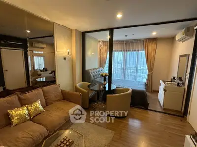 Modern open-plan living room with cozy seating and elegant bedroom view