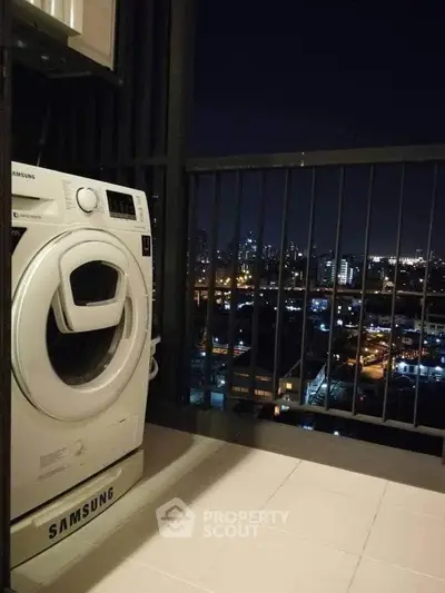 Modern balcony with city view and washing machine, perfect for urban living.