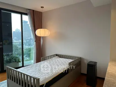 Cozy bedroom with single bed and city view, perfect for urban living.