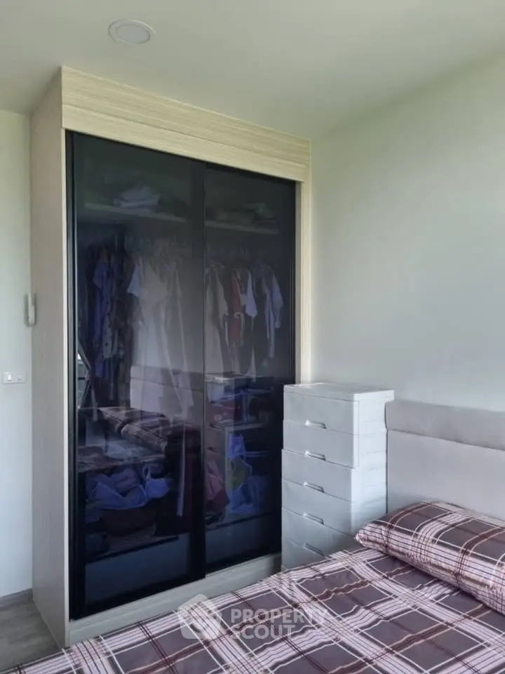 Modern bedroom with sleek wardrobe and stylish bedding