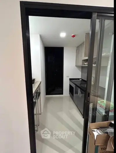Modern kitchen with sleek design and sliding glass door entry