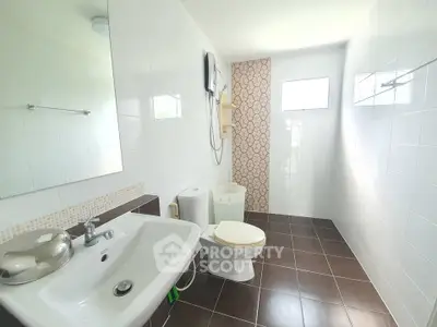 Spacious modern bathroom with sleek fixtures and natural light