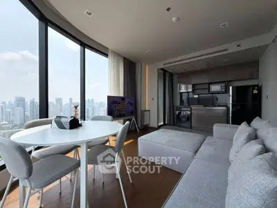 Luxurious modern living room with panoramic city view, sleek kitchen, and stylish furniture in high-rise apartment.
