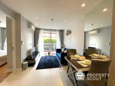 Spacious and modern living room with gleaming tiled floors, elegant dining setup, and cozy lounge area leading to a sunlit balcony.