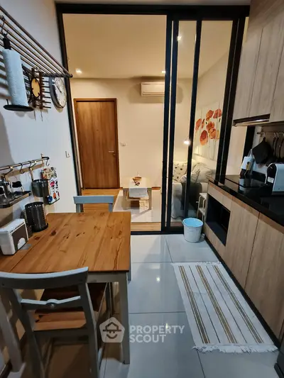 Cozy modern kitchen with wooden dining table and open layout to living room