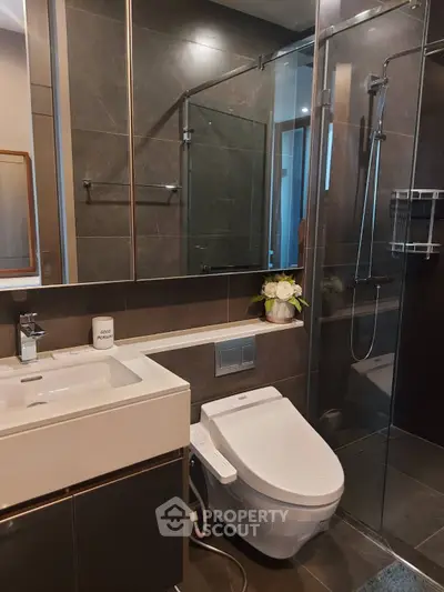 Modern bathroom with sleek fixtures and glass shower enclosure