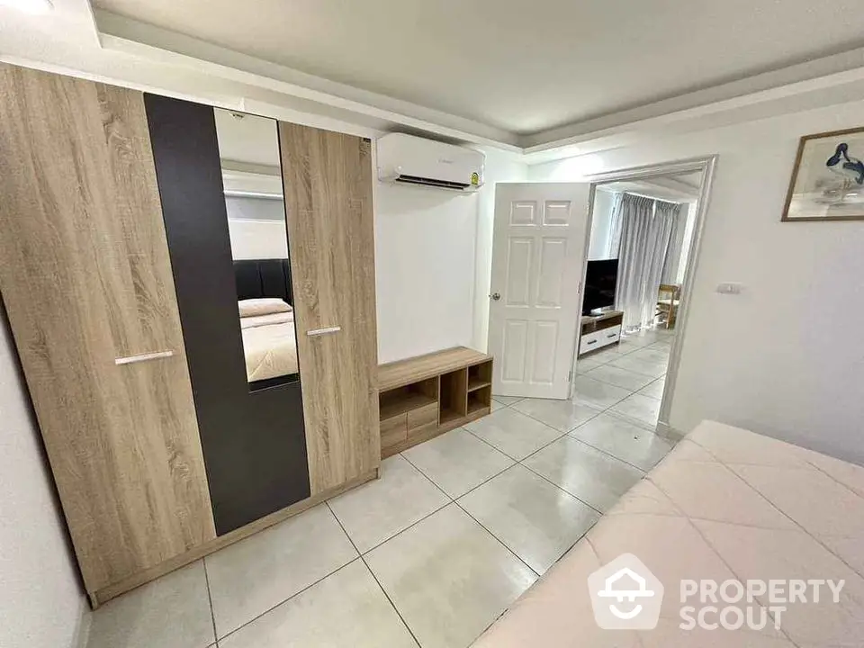 Modern bedroom with stylish wardrobe and air conditioning unit