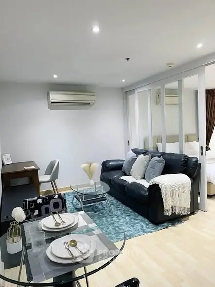 Modern living room with cozy sofa, dining area, and stylish decor in a contemporary apartment.