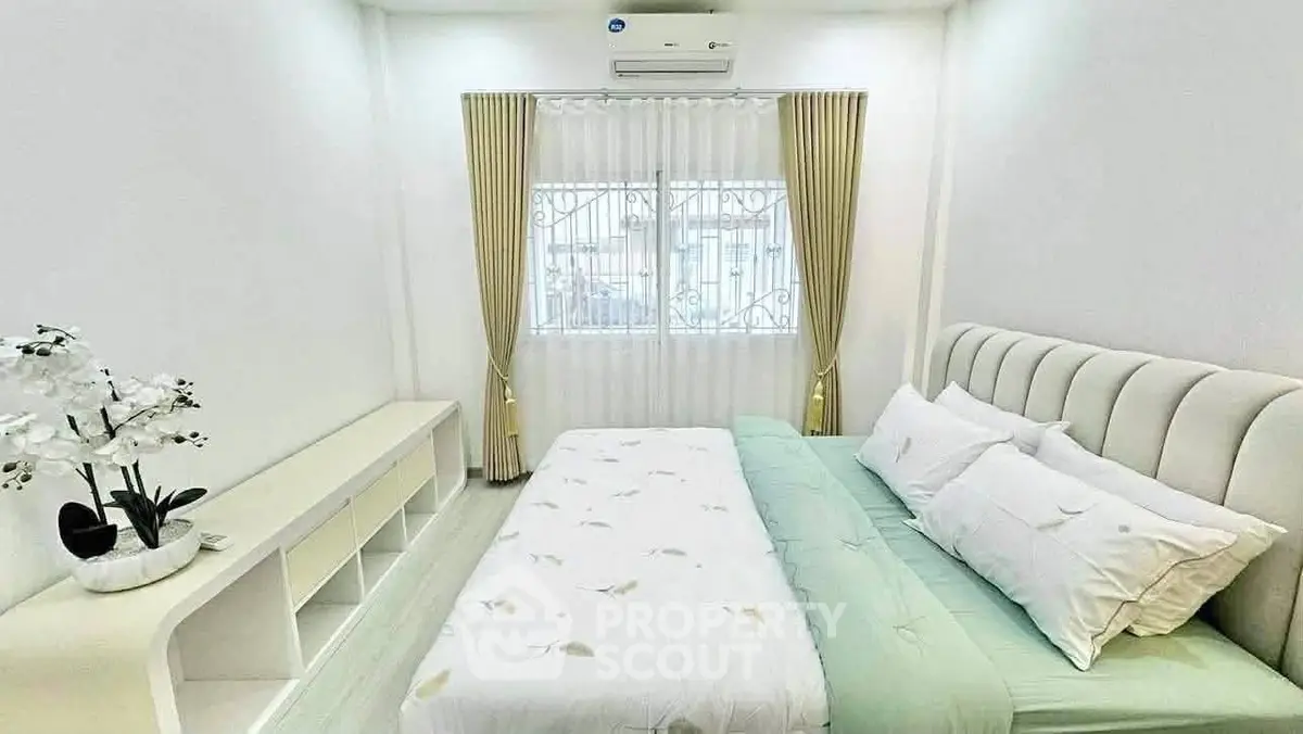 Bright and cozy bedroom with elegant decor and ample natural light.