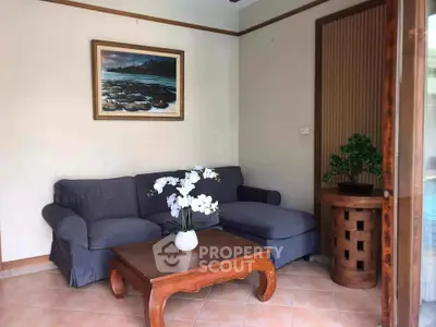 Cozy living room with elegant sofa and wooden coffee table, perfect for relaxation.