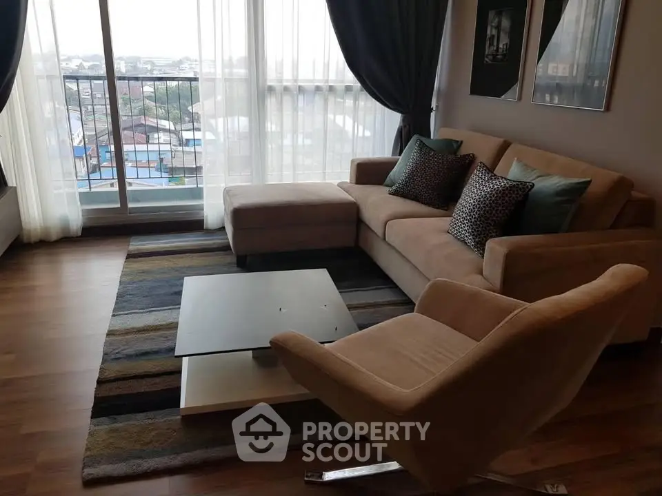 Stylish living room with modern furniture and large windows offering city views.